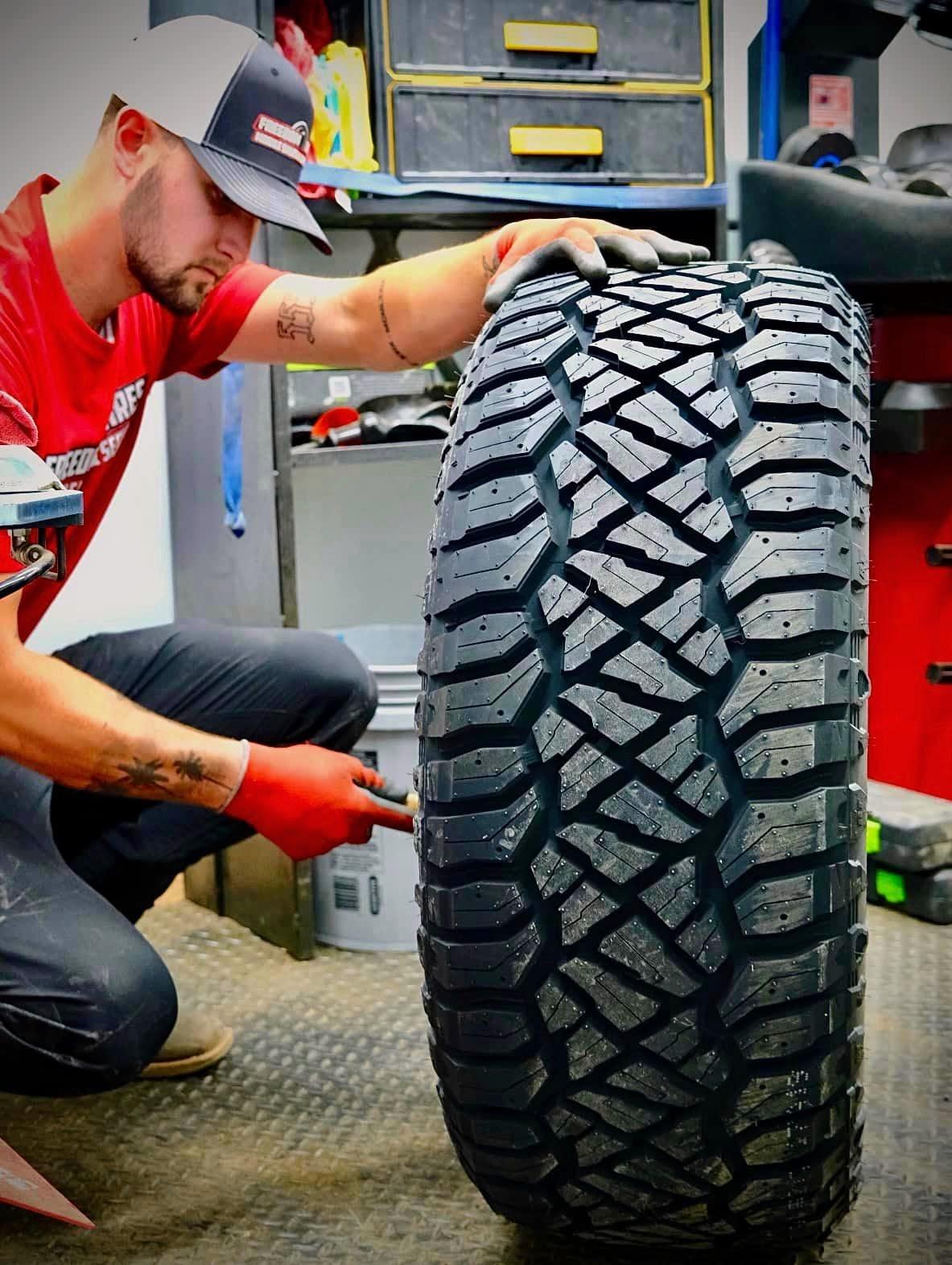 Freedom Tires operator working on vehicle tires on location